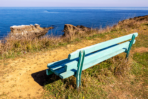 Old wooden empty bench at the rock formation Korabite or The Ship Rocks, village of Sinemorets, Bulgarian Black Sea Coast