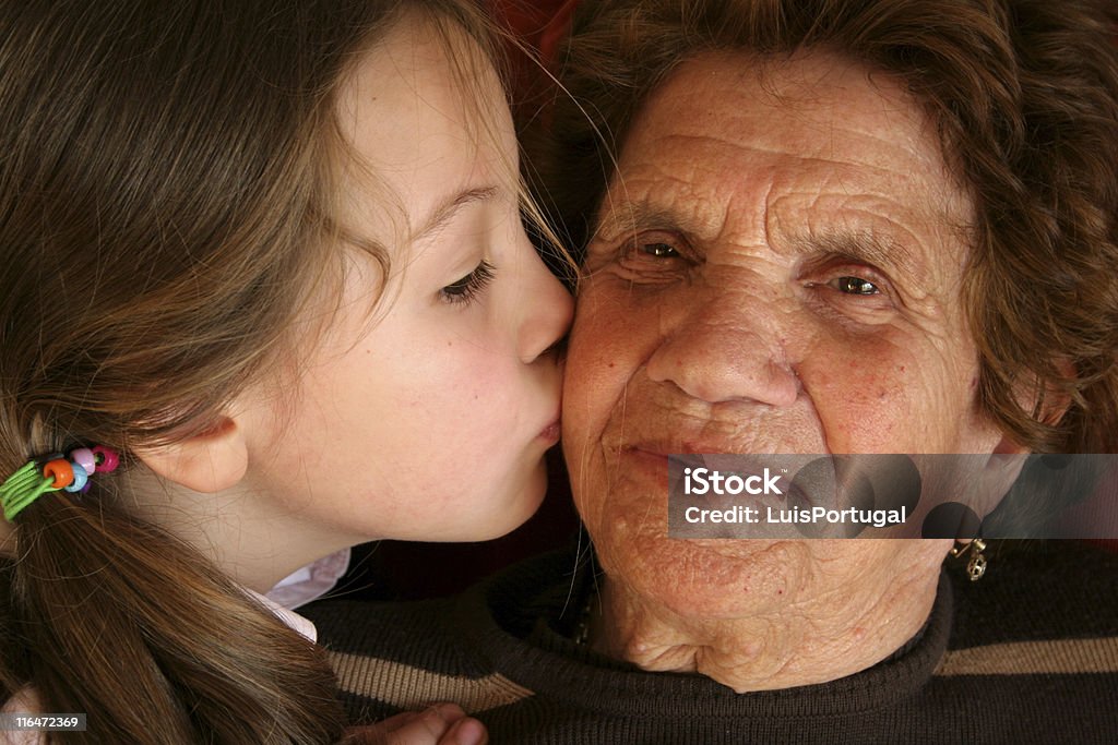 Love is Beautiful Thing Granddaughter Kiss your Grandmother 70-79 Years Stock Photo