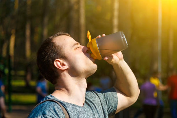 istock Close up young exhausted athlete drinking and pouring fresh water to refresh during running trail 1164725089