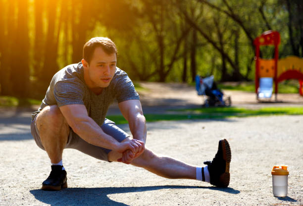 istock Close up healthy caucasian athlete stretching legs looking ahead 1164725122