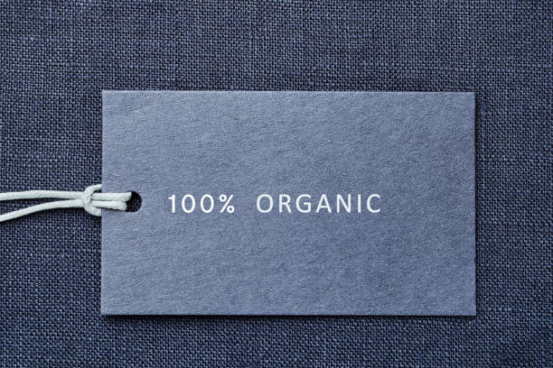 istock Label on linen fabric background. 100% organic materal 1164727111