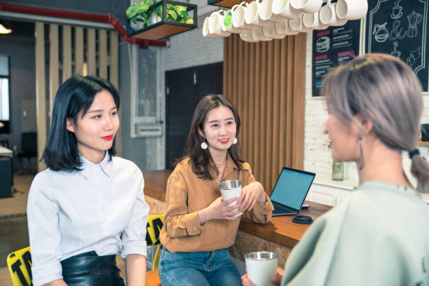 istock group of three friends drinking coffee in cafe shop 1164728829