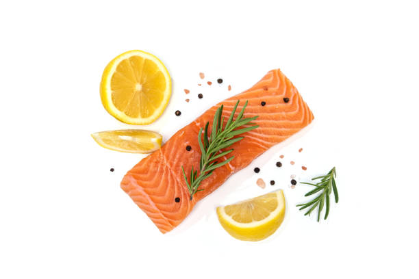 istock Fresh salmon steak with herbs and lemon isolated on white background 1164729219