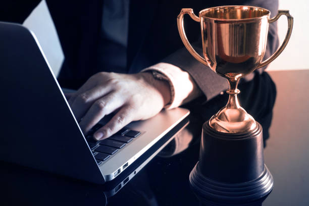 istock Glow trophy on successful businessman 's table, achive business concept. 1164730324