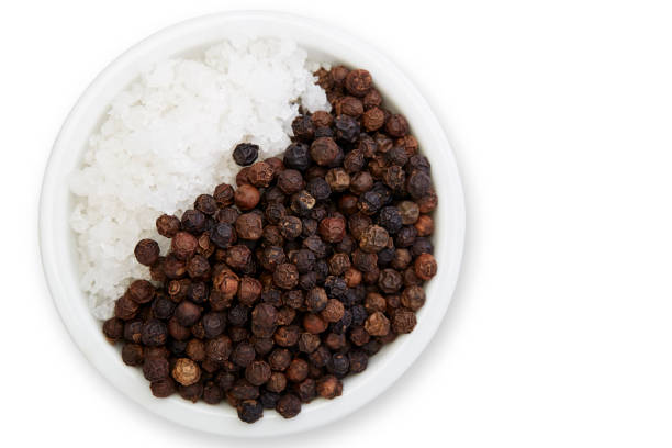 istock Bowl of black pepper with salt isolated on white background, 1164730799