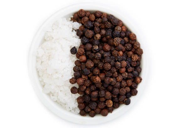 istock Bowl of black pepper with salt isolated on white background, 1164731377