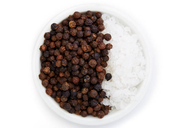 istock Bowl of black pepper with salt isolated on white background, 1164731383