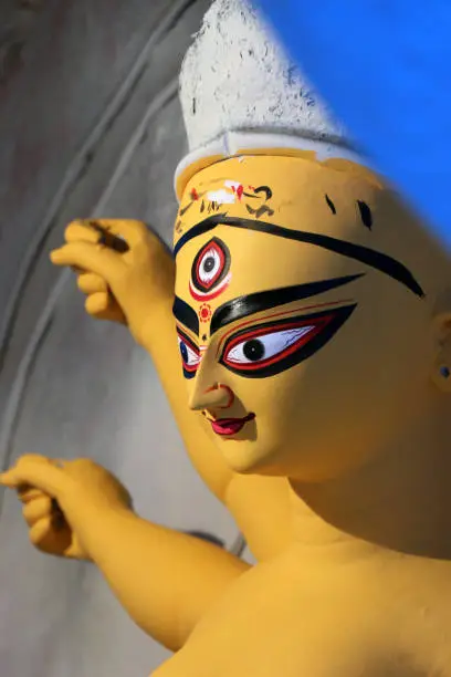 Photo of Portrait of Maa Durga. Idol of Hindu Goddess Durga during preparations in Kolkata.