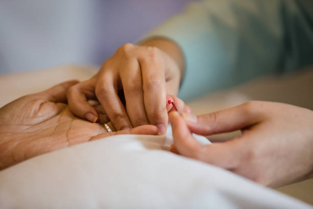 istock Process of drawing blood from a finger for hematocrit test. 1164731650