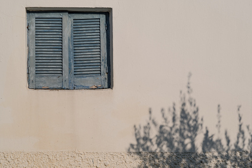 Small window on a weathered wall