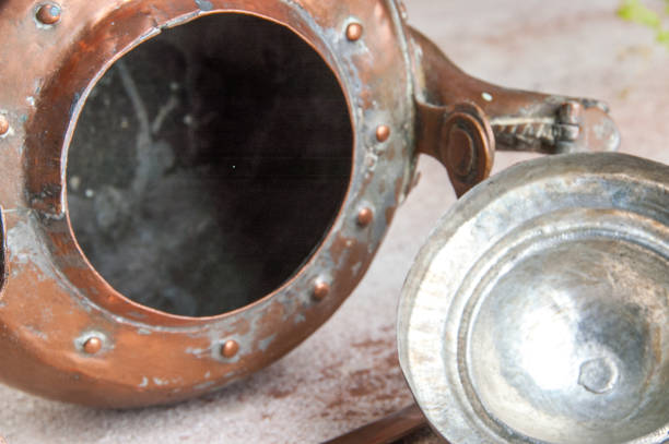 istock Antique copper kettle on concrete background. 1164736957