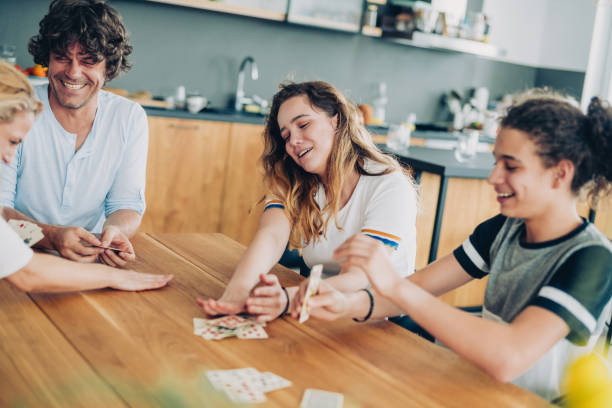 istock Cheerful Family Playing Cards 1164740275
