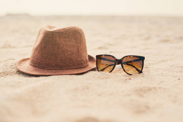 istock Sunglasses and hat on the sand 1164740287