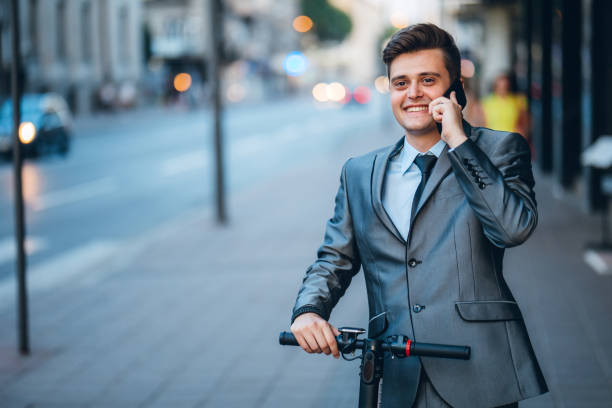 istock Businessman on electric push scooter 1164744411