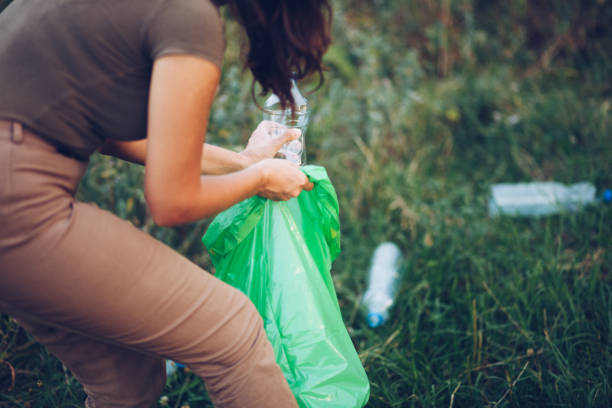 istock Volunteer collects plastic bottles outdoors 1164744473