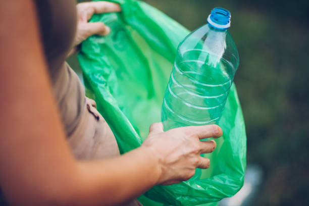 istock Volunteer collects plastic bottles outdoors 1164744685