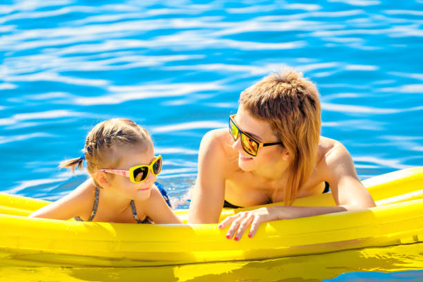 Lake, mom and child with hug for kayak, water activity or adventure for bonding together. River, mother and happy kid with support for canoeing, travel holiday and paddle outdoor as family in boat