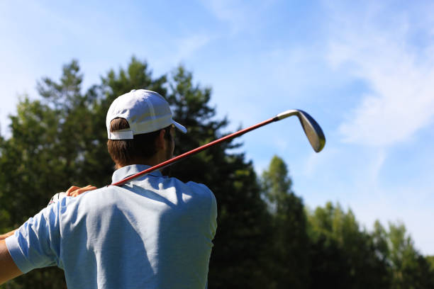 istock Athletic young man playing golf in golf club. 1164749760
