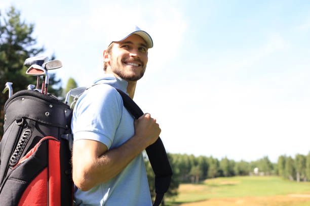 istock Golf player walking and carrying bag on course during summer game golfing. 1164749766