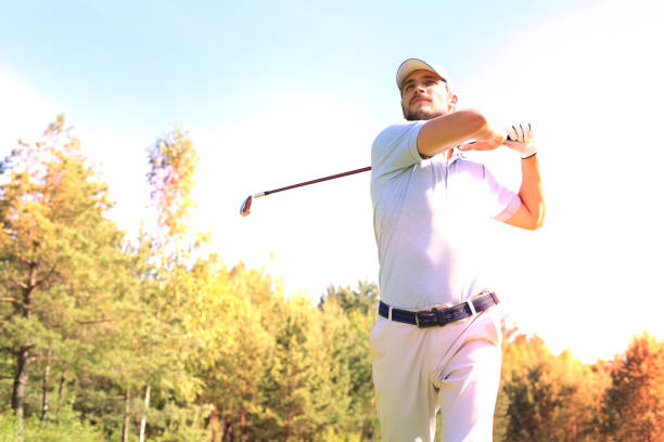 istock Golfer hitting golf shot with club on course while on summer vacation. 1164749810