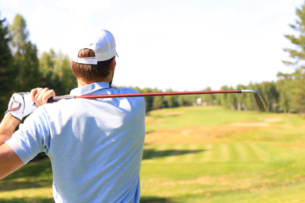 istock Athletic young man playing golf in golf club. 1164749882