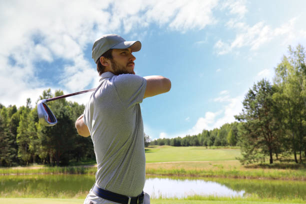 istock Golfer hitting golf shot with club on course while on summer vacation. 1164750569