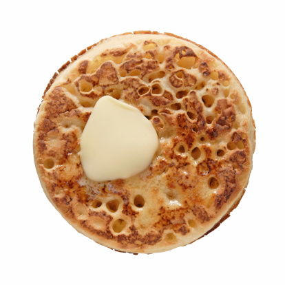 buttered crumpet, shot from the top, isolated