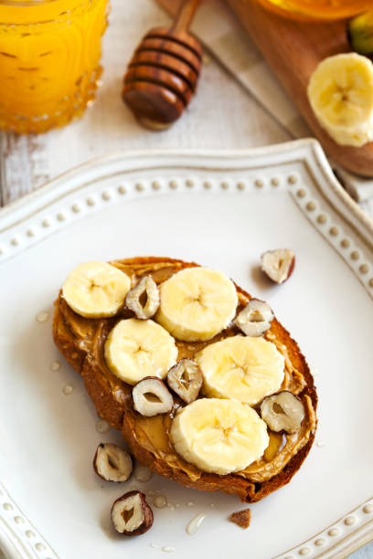 istock Toast with bananas, peanut butter, nuts and honey 1164753717