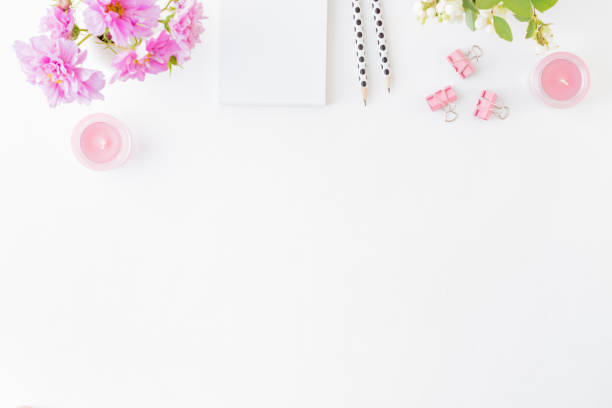 istock Flat lay blogger or freelancer workspace with a notebook, pink flowers on a white background 1164753908