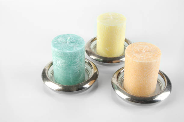 istock Candles in glass coasters on white background. 1164754997