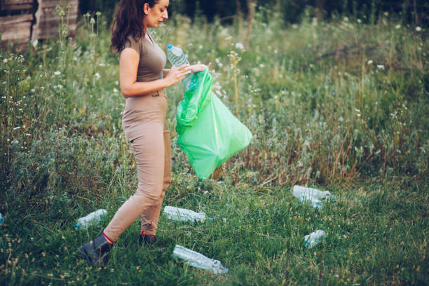 istock Volunteer collects plastic bottles outdoors 1164754998
