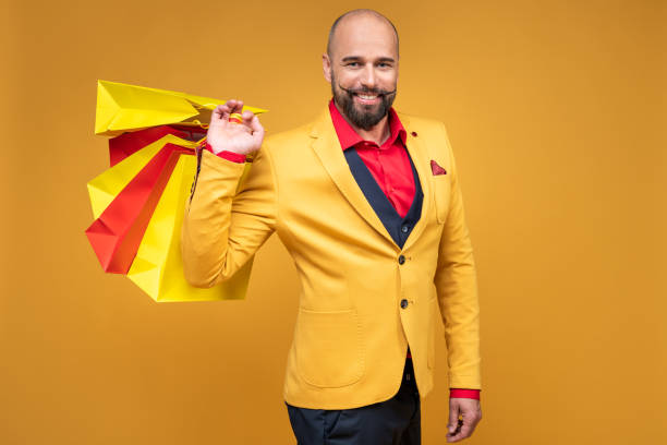 istock Happy well dressed gentleman with shopping bags 1164756225