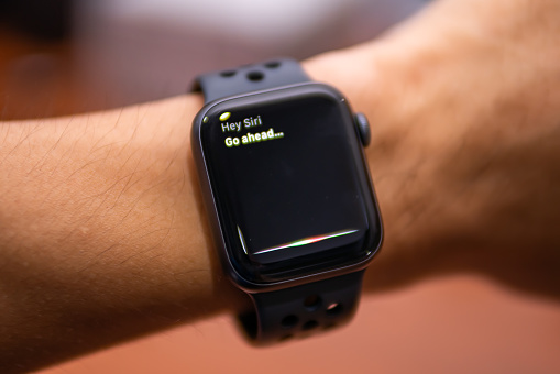 Bangkok, Thailand - July 27, 2019 : Apple Watch Nike+ Series 4 showing its screen with Siri, Apple's voice-activated digital assistant.