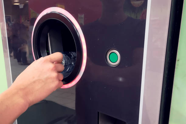 istock Shoppers return bottles and cans of reusable packagings in a reverse vending machine. Environmental protection concept 1164760411