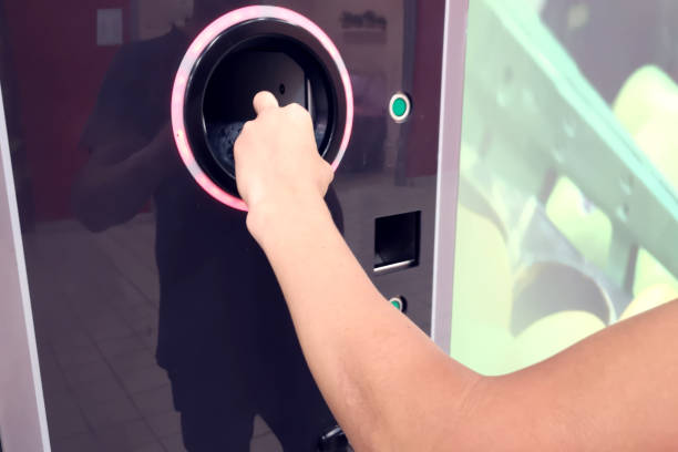 istock Shoppers return bottles and cans of reusable packagings in a reverse vending machine. Environmental protection concept 1164760417