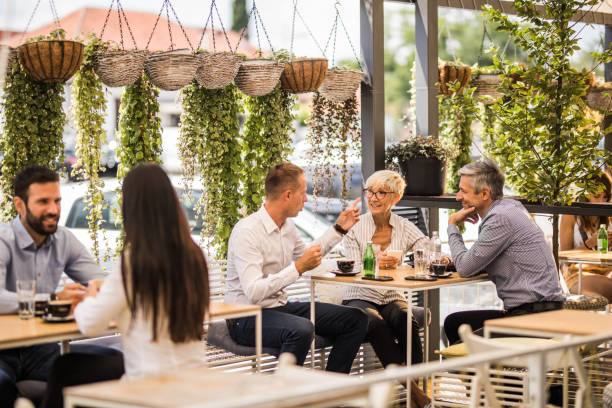 istock Group of business people talking while relaxing on in a cafe. 1164762152