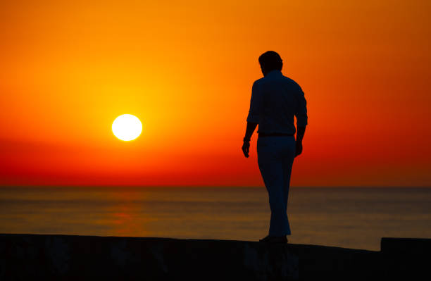istock Man enjoying colorful sunset or sunrise 1164762261