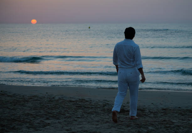 istock Man enjoying colorful sunset or sunrise 1164763184