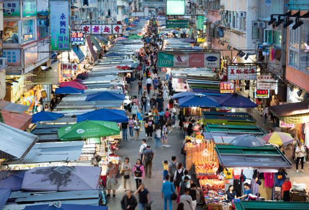 istock Woman using phone, motioned blurred market 1164763310
