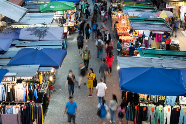 istock Woman using phone, motioned blurred market 1164763323