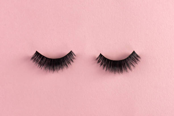 Eyelashes Eyelashes on pink paper background. false lashes stock pictures, royalty-free photos & images