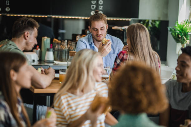 istock Group of university students having lunch break at cafeteria. 1164763605