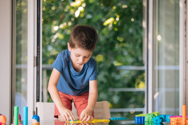 istock Preschool boy playing with child's play clay 1164763812