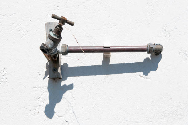 istock A tap with a short pipe on a white wall 1164764874