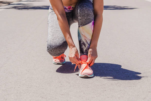 istock Girl tying her shoelace 1164764989