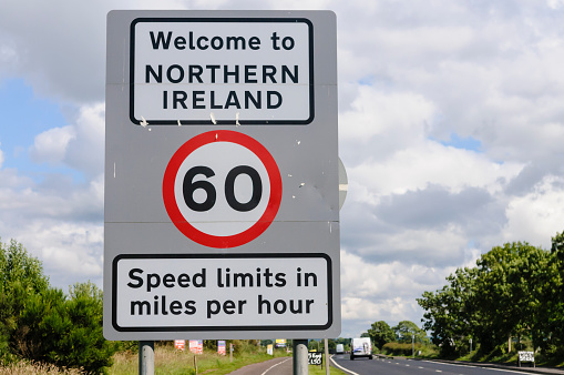 Road Sign at the Northern Ireland border with the Irish Republic welcoming people to Northern Ireland and a reminder that speed limits are in mph.