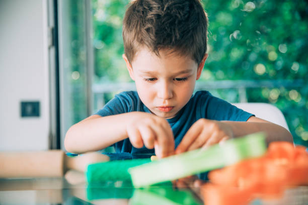 niño en edad preescolar jugando con arcilla de juego del niño - food child childs play clay craft fotografías e imágenes de stock