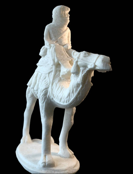 istock The figurine is white, the man on a camel, isolate. 1164767460