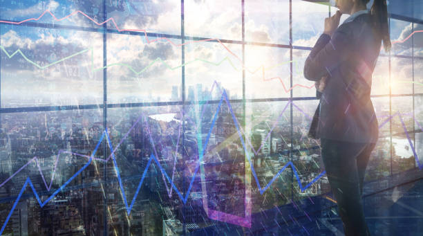 Young woman in suit in front of the glass screen which reflects business growth charts and diagrams and falling digits. Business background and City of London skyscrapers at the back Young woman in suit in front of the glass screen which reflects business growth charts and diagrams and falling digits. Business background and City of London skyscrapers at the back environment computer cloud leadership stock pictures, royalty-free photos & images