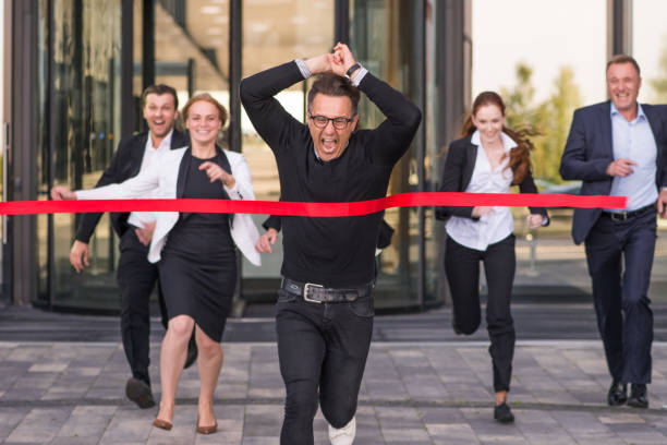 istock Business people crossing red finish line 1164778974